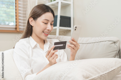 Online internet banking, asian young woman hand in payment spending by scan qr code, use phone, mobile to transfer money or pay money of credit card without cash at home. Technology of financial.