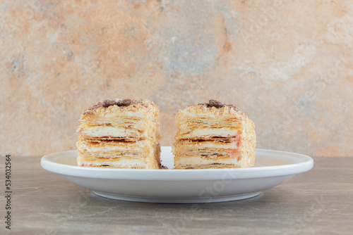 Slices of napoleon cake on white plate