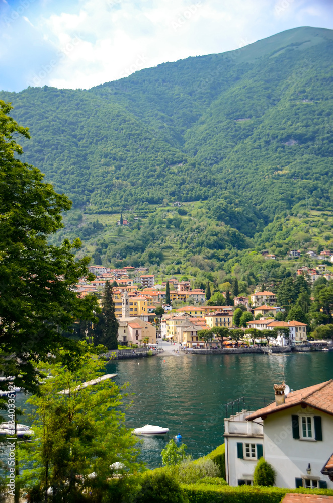 Scenic view in Como lake, Italy with waterfront town and mountain in the back. Summer holidays and travel destinations in Europe for relaxation and romance