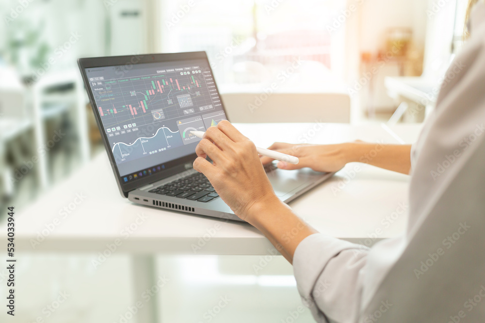 Fototapeta premium Women analysis of digital market and investment in block chain crypto currency by computer.