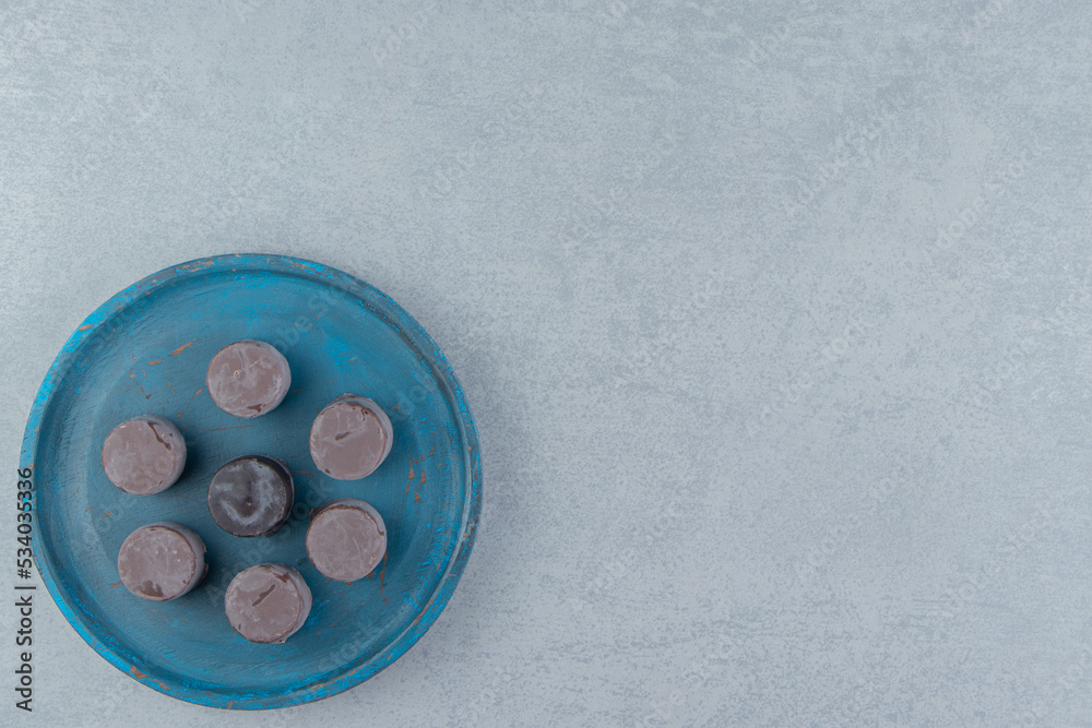 Desserts on blue tray, on the marble background Desserts on blue tray, on the marble background