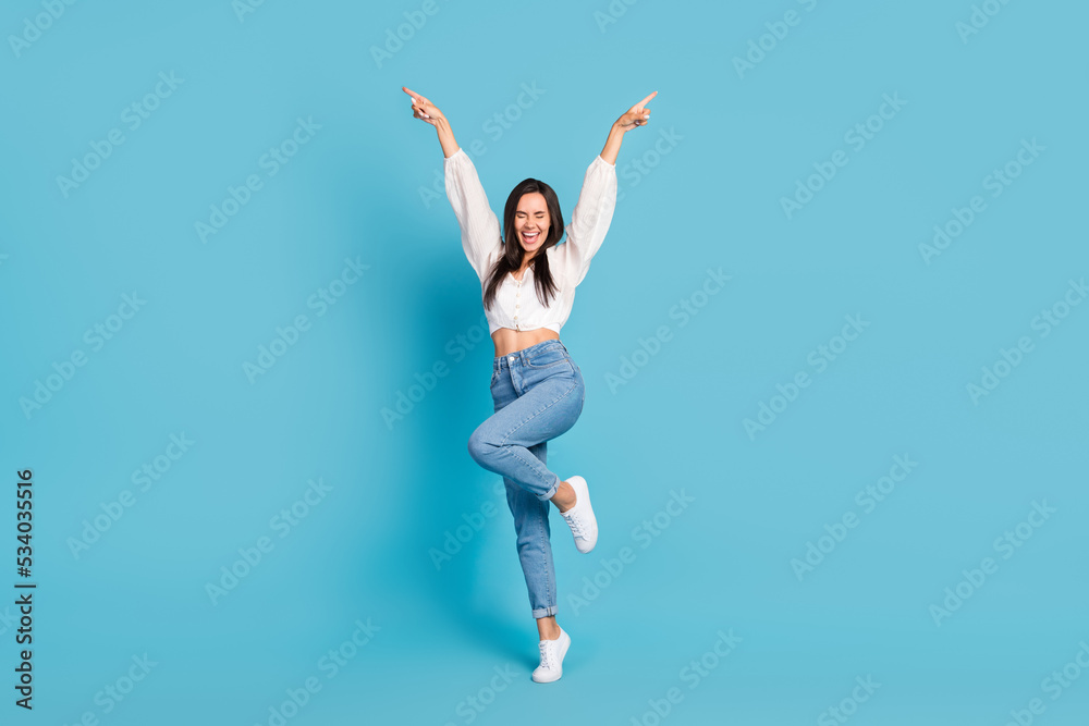 Full length portrait of overjoyed gorgeous person point fingers dance enjoy discotheque isolated on blue color background