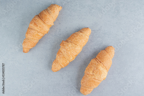Three flavorful croissant   on the marble background