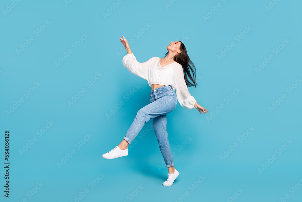 Full body portrait of adorable cheerful lady enjoy chilling dance isolated on blue color background Full body portrait of adorable cheerful lady enjoy chilling dance isolated on blue color background