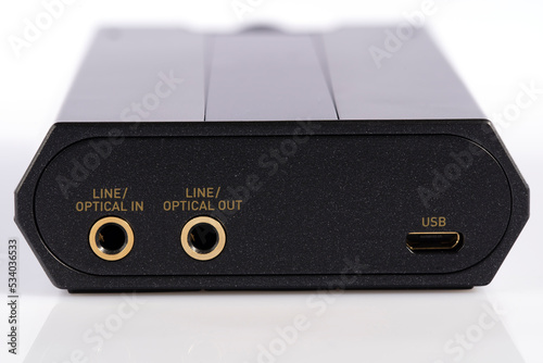 Detail of the optical input and output and USB port of an external sound card and DAC isolated on white