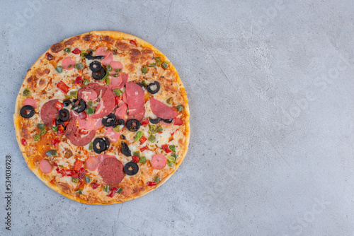 Delicious pizza displayed on marble background