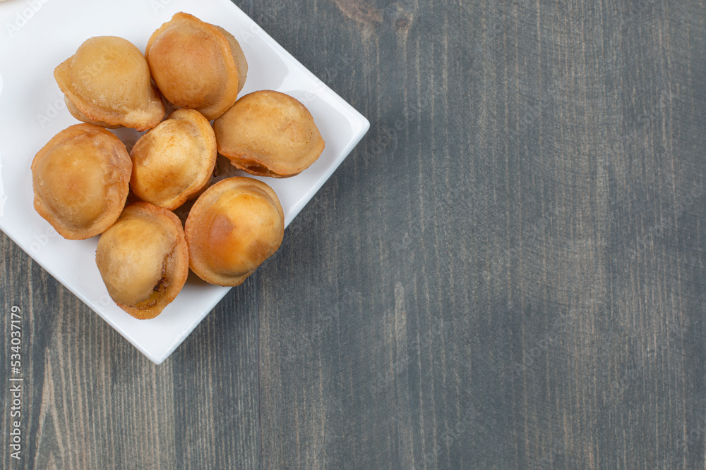 Fried delicious dumplings in a white plate Fried delicious dumplings in a white plate