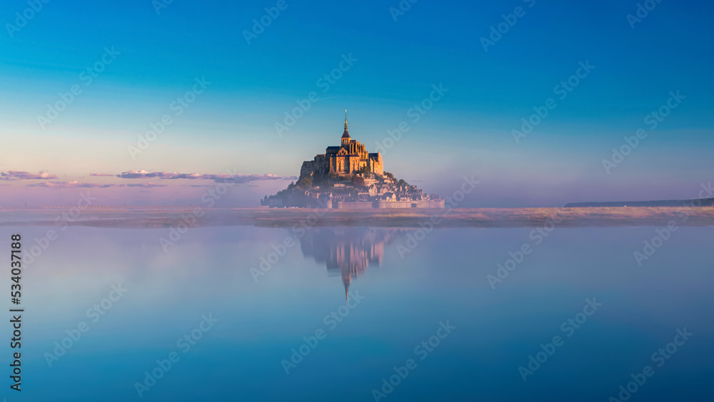 Breathtaking sunrise at the famous Le Mont Saint-Michel tidal island , Normandy, France