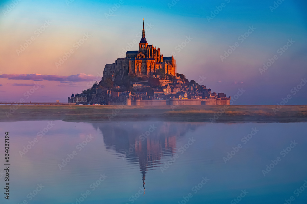 Breathtaking sunrise at the famous Le Mont Saint-Michel tidal island , Normandy, France