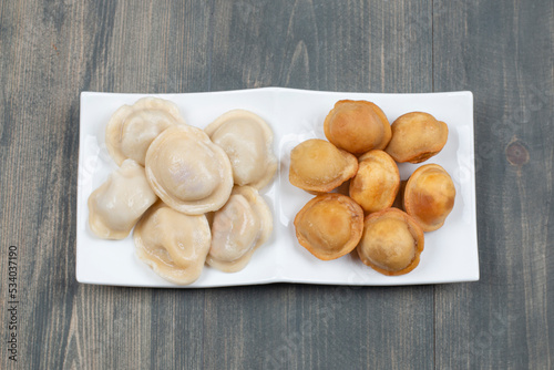 Fried and boiled delicious dumplings in a white plate