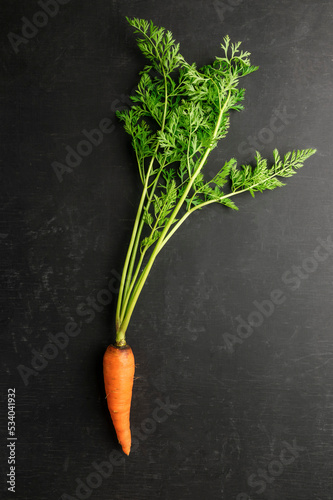 Fresh carrots and beets on a dark wooden background. Vegan dinner ingredients. Dietary product. Healthy food.