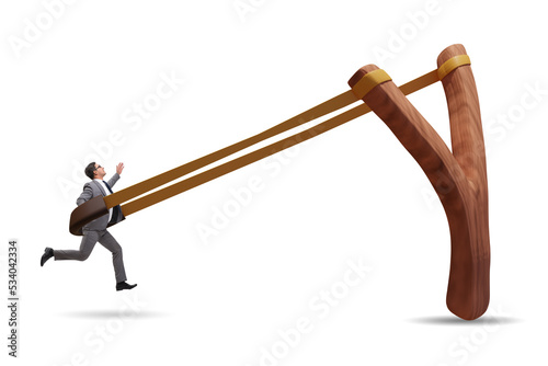 Businessman being launched from slingshot in career concept photo