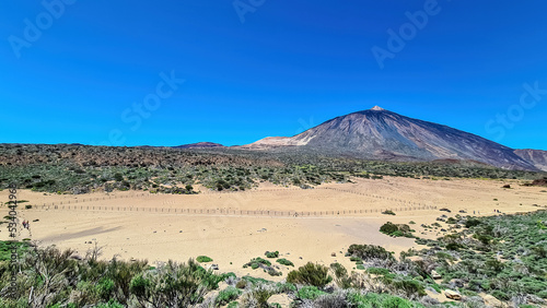 La Canada de los Guancheros dry desert plain with scenic view on volcano Pico del Teide, Mount El Teide National Park, Tenerife, Canary Islands, Spain, Europe. Hiking trail to Riscos de la Fortaleza photo