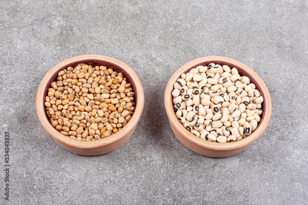 Pile of raw beans in wooden bowls Pile of raw beans in wooden bowls