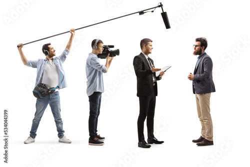 Camera man and sound engineer recording a conversation between men