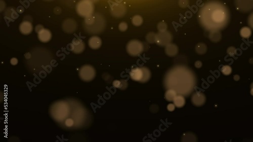 Golden glowing dust particles. Christmas light, bokeh. Blurred motion. Glowing dust, golden light.