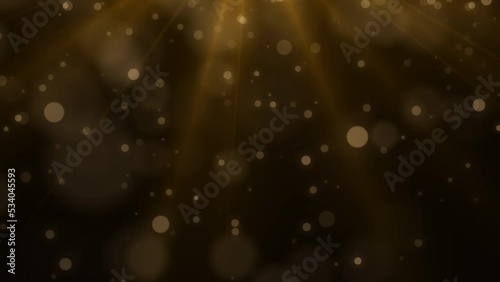 Golden glowing dust particles. Christmas light, bokeh. Blurred motion. Glowing dust, golden light.