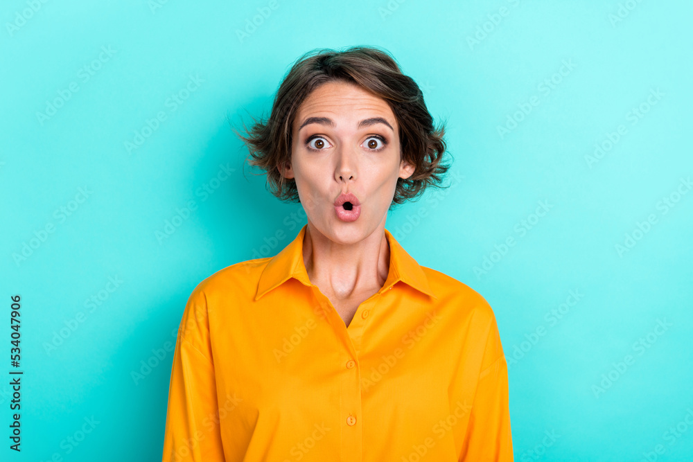 Photo of cute impressed excited girl with bob hairdo dressed yellow shirt staring at super sale isolated on turquoise color background Photo of cute impressed excited girl with bob hairdo dressed yellow shirt staring at super sale isolated on turquoise color background