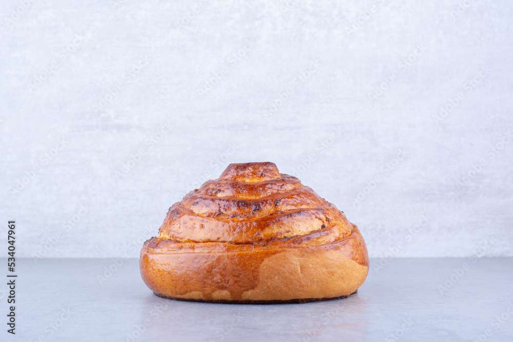 Crisp sweet bun displayed on marble background Crisp sweet bun displayed on marble background