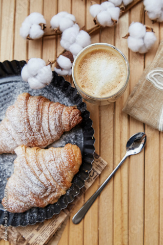 Aesthetic french breakfast with fresh croissants, latte. Autumn coziness. Cotton decoration. Pastel stories background.