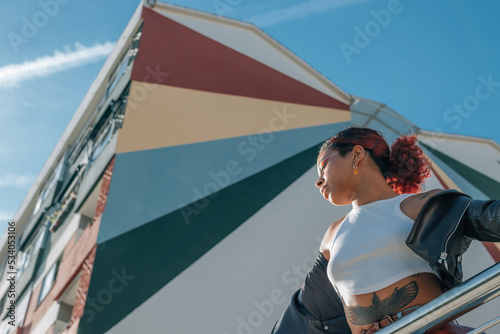latina black girl in the street with urban building in the background