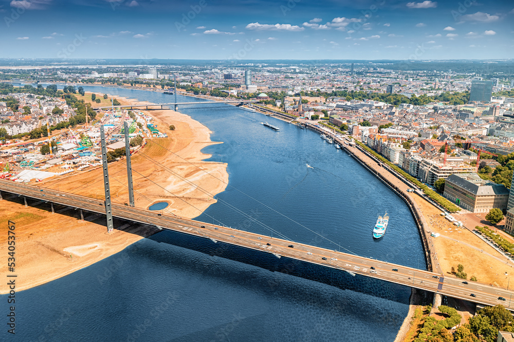 Aerial panoramic cityscape view of suspension automobile bridge Rheinkniebrucke over the Rhine River in Dusseldorf, Germany