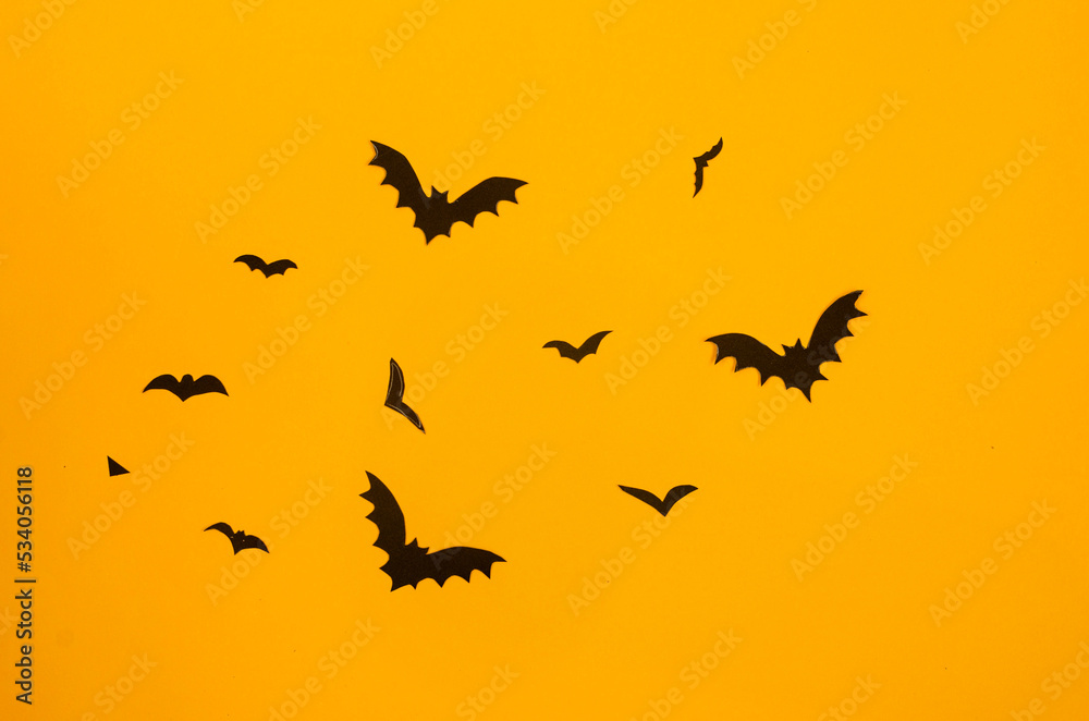 yellow background with black paper bats Stock Photo | Adobe Stock