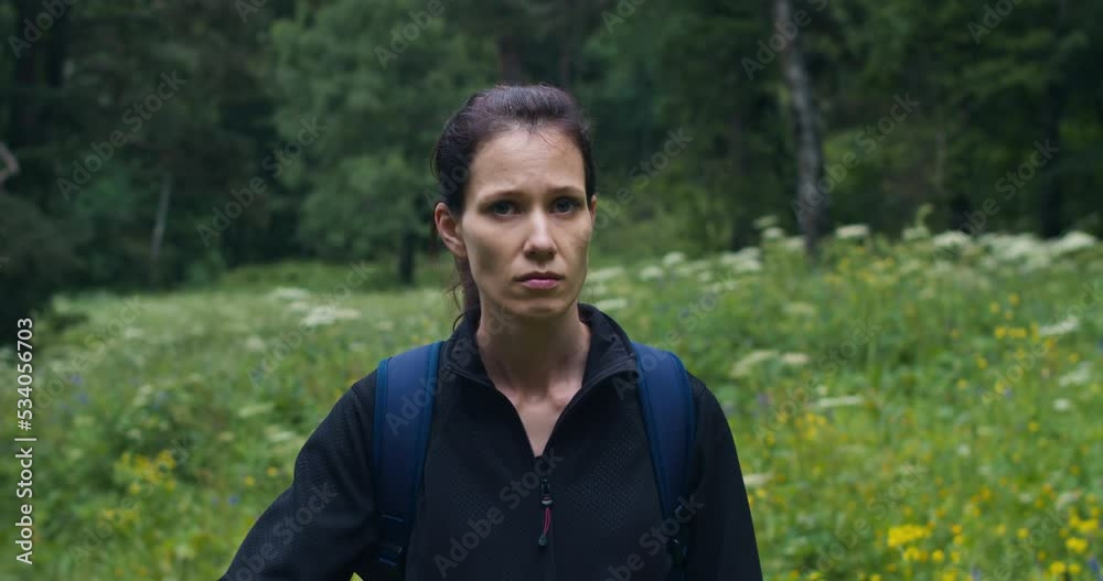 Solo woman hiker middle of meadow in pine autumn forest, enjoys nature Solo woman hiker middle of meadow in pine autumn forest, enjoys nature