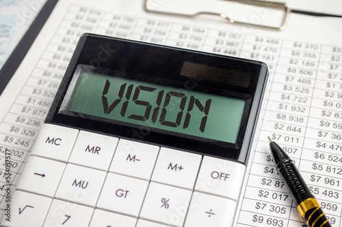 vision word on calculator display and pen, charts and documents