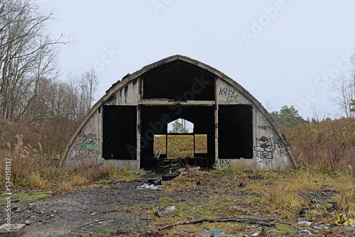 Abandoned shed in Astangu nature reserve, surrounded by shrubs and bare trees. Tallinn, Estonia photo