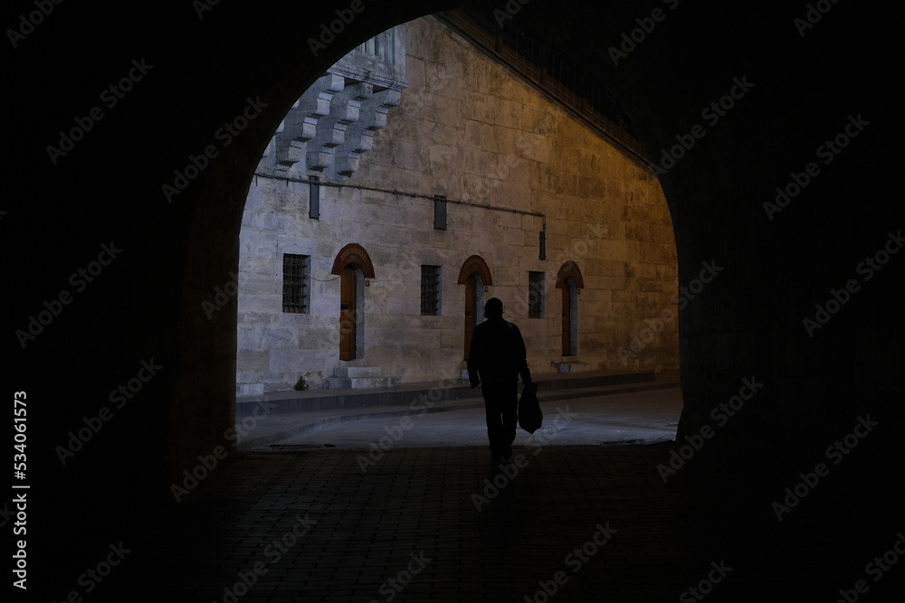 silhouette of a person walking in the night