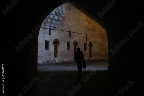 silhouette of a person walking in the night