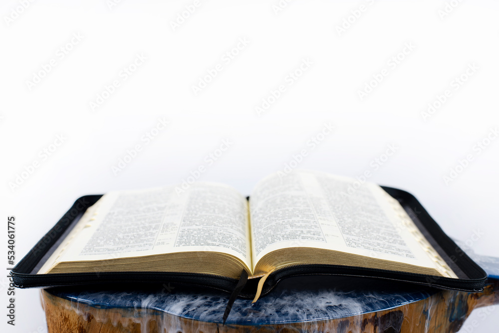 Open bible on the table. Holy Scripture on a white background. Open bible on the table. Holy Scripture on a white background.
