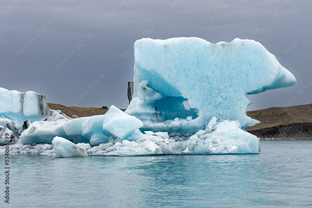 Jökulsárlón is a glacial lagoon bordering the Vatnajökull National Park in south-east Iceland. Its calm blue waters are dotted with icebergs from the nearby Breiðamerkurjökull glacier.