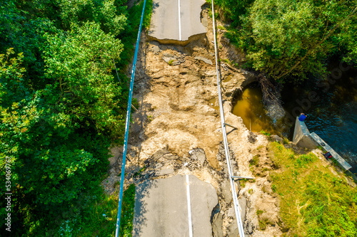 The asphalt road and bridge washed out and destroyed after the heavy rain and flood. Aerial photo photo