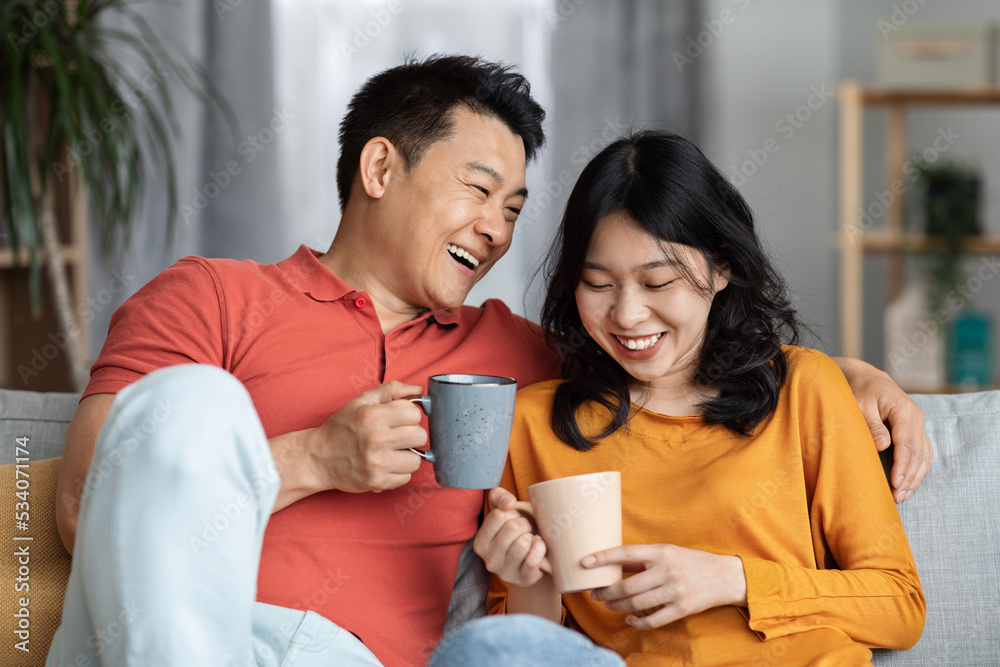 Closeup of loving asian spouses drinking tea together Closeup of loving asian spouses drinking tea together