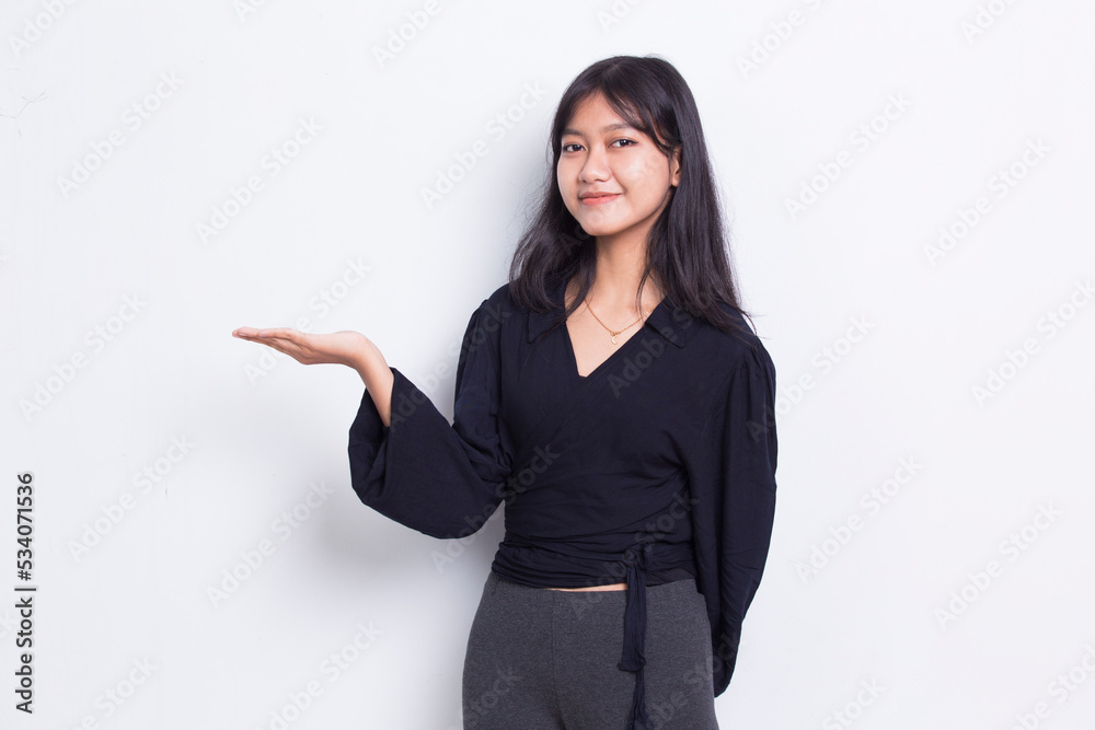 Happy young asian woman pointing with fingers to different directions isolated on white background
Happy young asian woman pointing with fingers to different directions isolated on white background