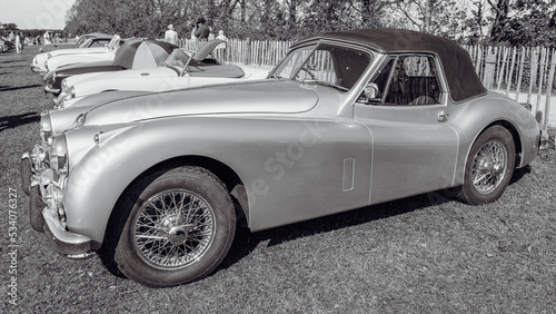 Classic British sports car in monochrome.