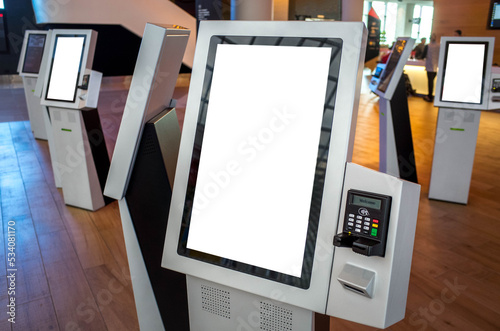 Blank white mockup background texture template of a kiosk machine with a touch screen and an attached POS machine. Copy space on a smart interactive machine service device for customer self-checkout. photo