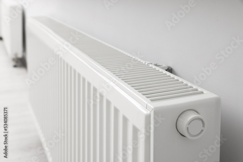 Wallpaper Mural Modern radiator on white wall in room, closeup. Central heating system Torontodigital.ca
