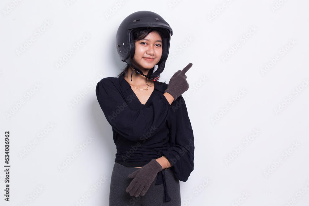 beautiful asian woman wearing motorcycle helmet pointing with fingers to different directions isolated on white background beautiful asian woman wearing motorcycle helmet pointing with fingers to different directions isolated on white background
