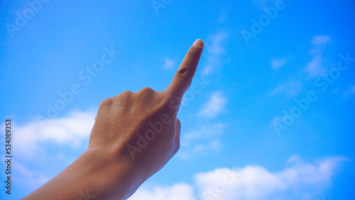 Male fist isolated on blue sky background. Asian hand make sign number 1. Counting, brave, masculinity concept