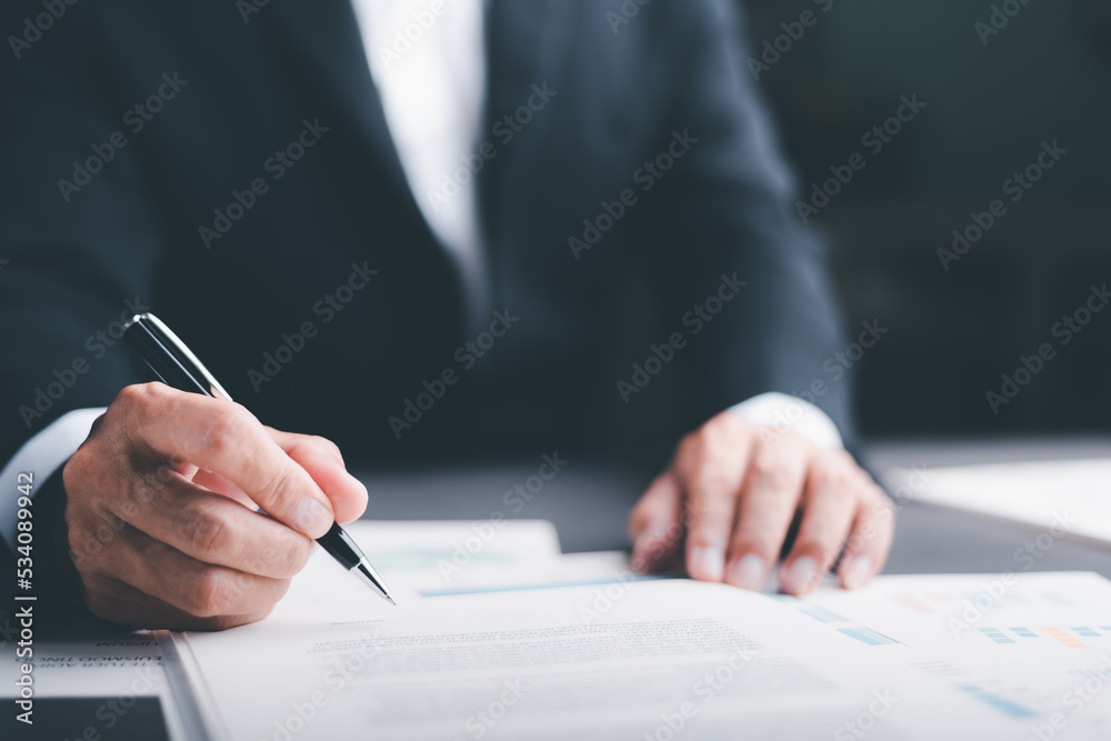 Businessman validates and manages business documents and agreements. , signing a business contract approval of contract documents confirmation or warranty certificate Businessman validates and manages business documents and agreements. , signing a business contract approval of contract documents confirmation or warranty certificate