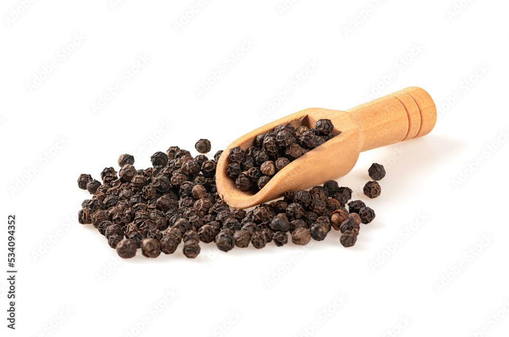 Black pepper in wooden scoop on white background. Black pepper in wooden scoop on white background.