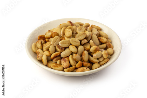 dried coffee beans with hull or parchment skin on white plate, coffea arabica, pulp and skin or flesh of the coffee cherry is removed from the beans, processing step on white background