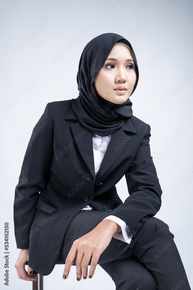 Portrait of an attractive Muslim woman wearing business attire and hijab with a corporate pose isolated on white background. For image cut-out for technology, business or finance. Portrait of an attractive Muslim woman wearing business attire and hijab with a corporate pose isolated on white background. For image cut-out for technology, business or finance.
