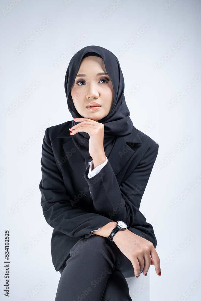 Portrait of an attractive Muslim woman wearing business attire and hijab with a corporate pose isolated on white background. For image cut-out for technology, business or finance. Portrait of an attractive Muslim woman wearing business attire and hijab with a corporate pose isolated on white background. For image cut-out for technology, business or finance.
