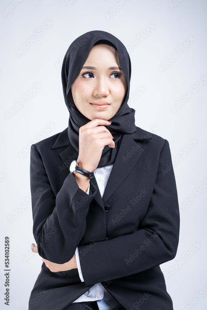Portrait of an attractive Muslim woman wearing business attire and hijab with a corporate pose isolated on white background. For image cut-out for technology, business or finance. Portrait of an attractive Muslim woman wearing business attire and hijab with a corporate pose isolated on white background. For image cut-out for technology, business or finance.