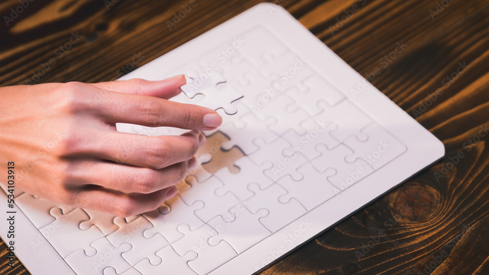 Close-up of business hands connecting jigsaw puzzle, business problem solving, success and goal achievement, the last jigsaw is the link of all the pieces. Close-up of business hands connecting jigsaw puzzle, business problem solving, success and goal achievement, the last jigsaw is the link of all the pieces.