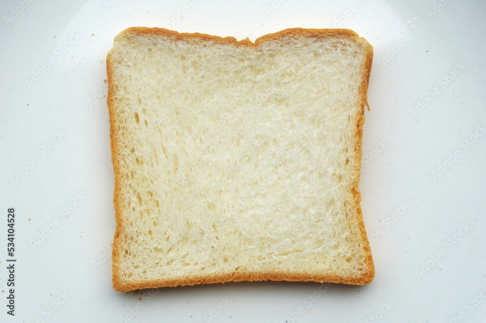 A slice of bread tender texture isolated on white plate background A slice of bread tender texture isolated on white plate background